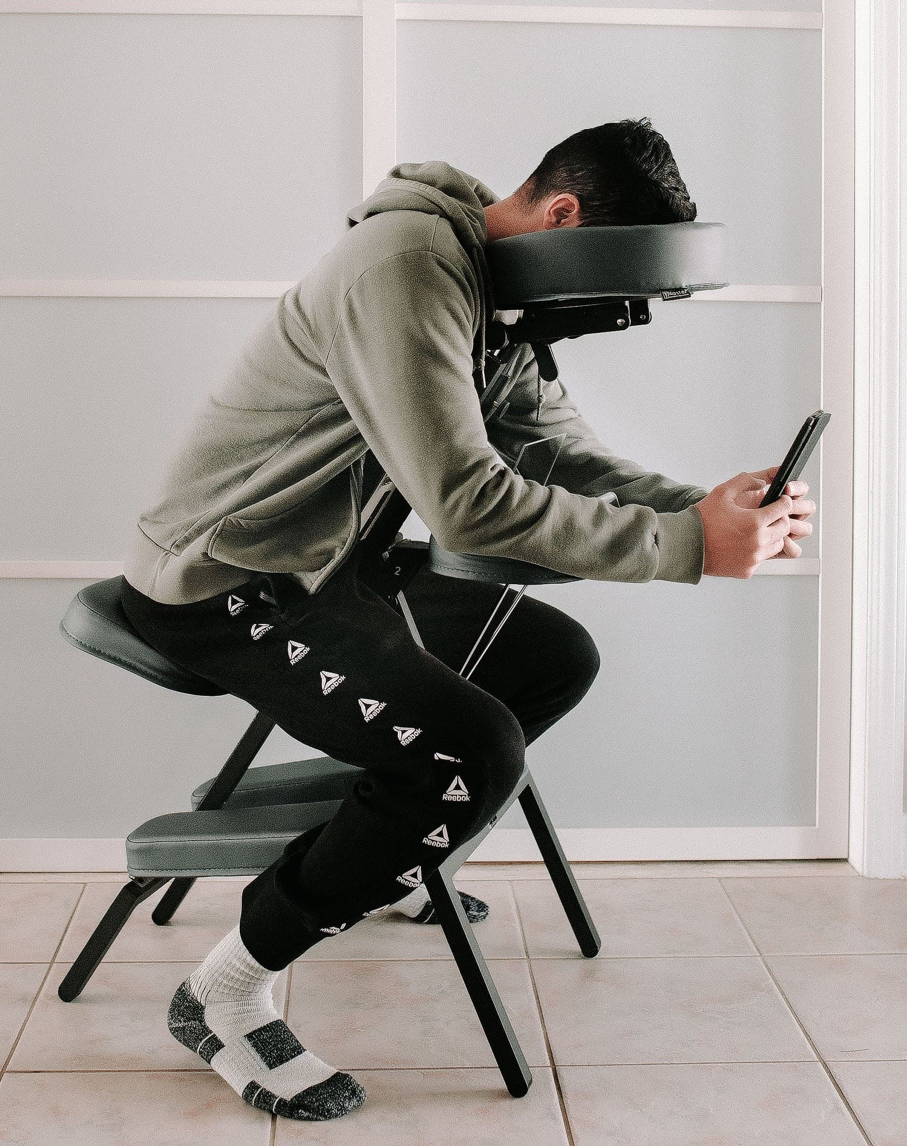 Patient sitting in a face down recovery chair