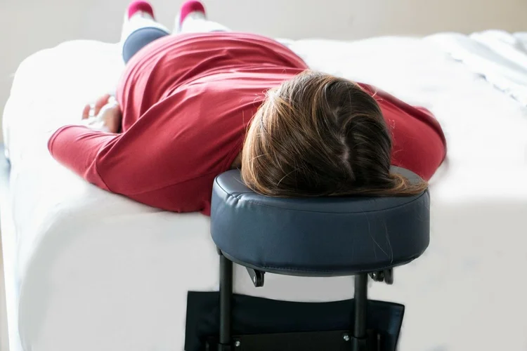 Patient using a face-down mattress attachment